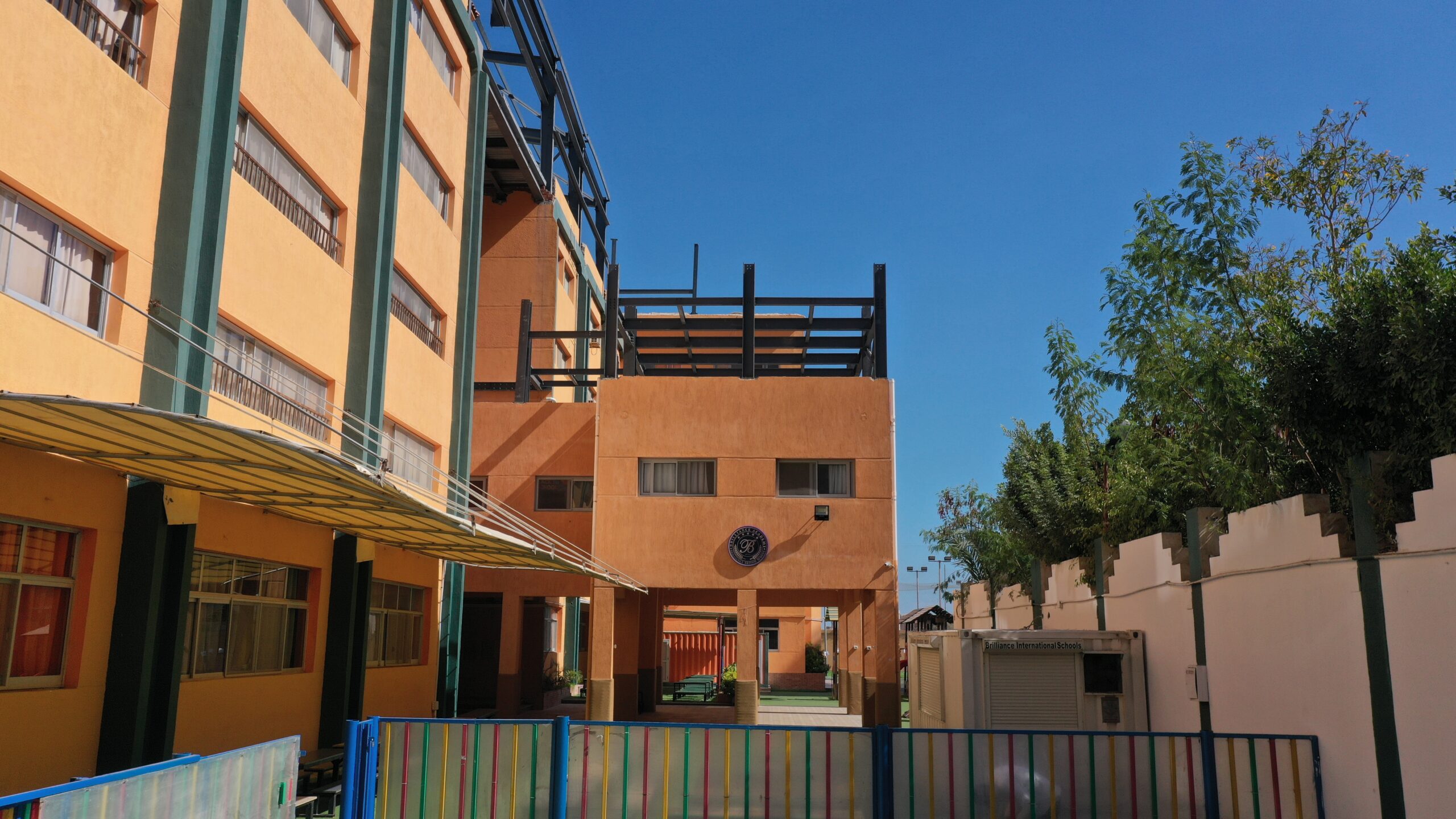 Brilliance Academy campus courtyard and school building